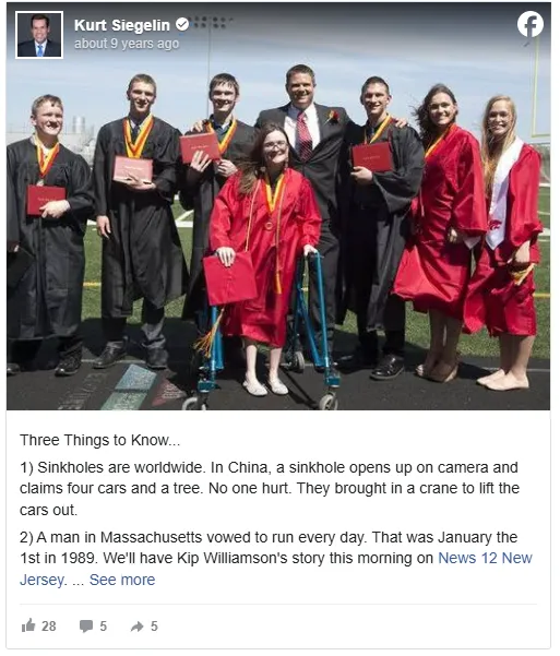 Seven high school graduates in matching caps and gowns standing together, symbolizing their achievement.