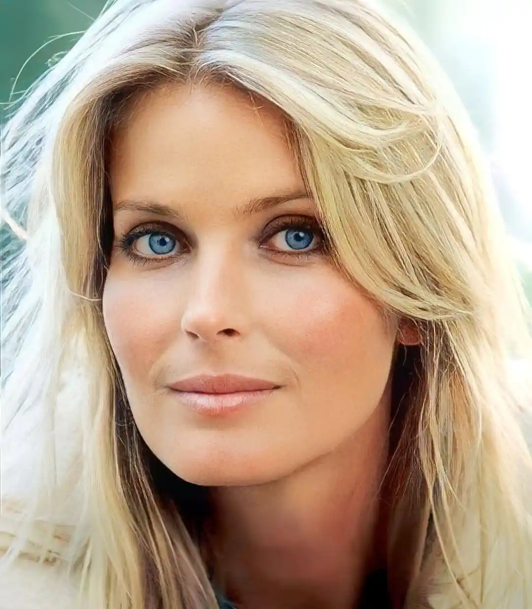 An elegant, recent portrait of Bo Derek at age 69, showing her beautiful blue eyes and confident smile.