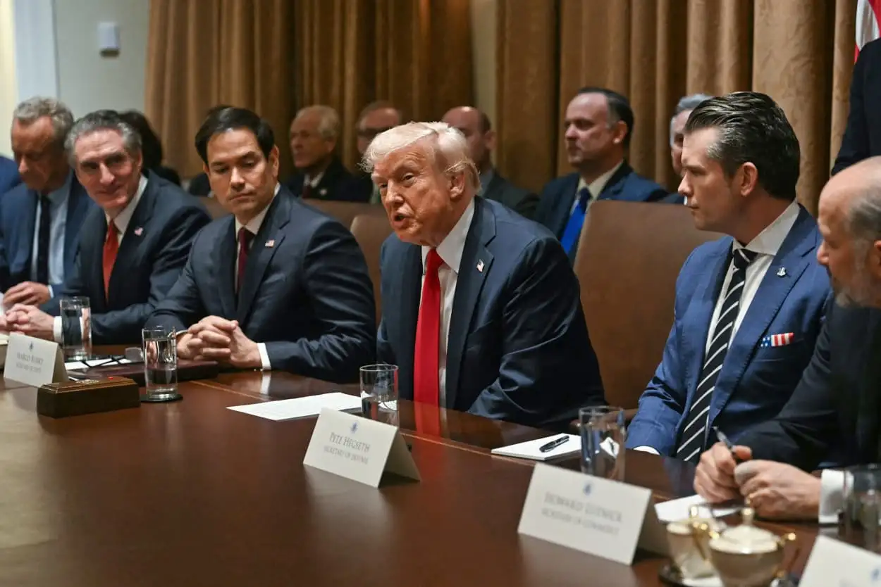President Donald Trump speaking at a Cabinet meeting in the White House, discussing tariff revenue and dividend checks.