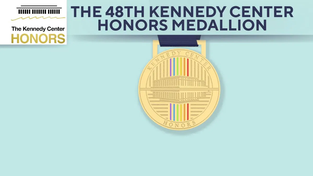 A close-up shot of the newly redesigned Kennedy Center Honors gold medallion on a navy blue ribbon.