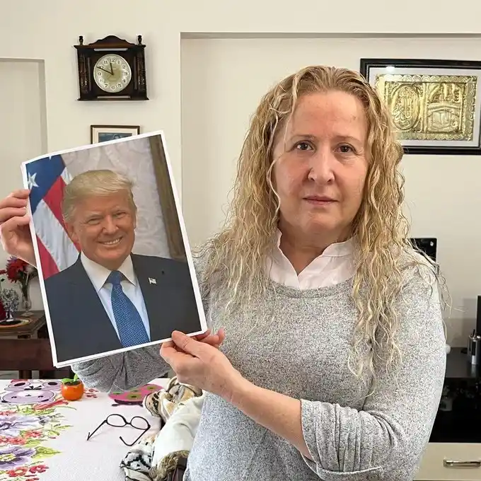 A woman watching Donald Trump on the news