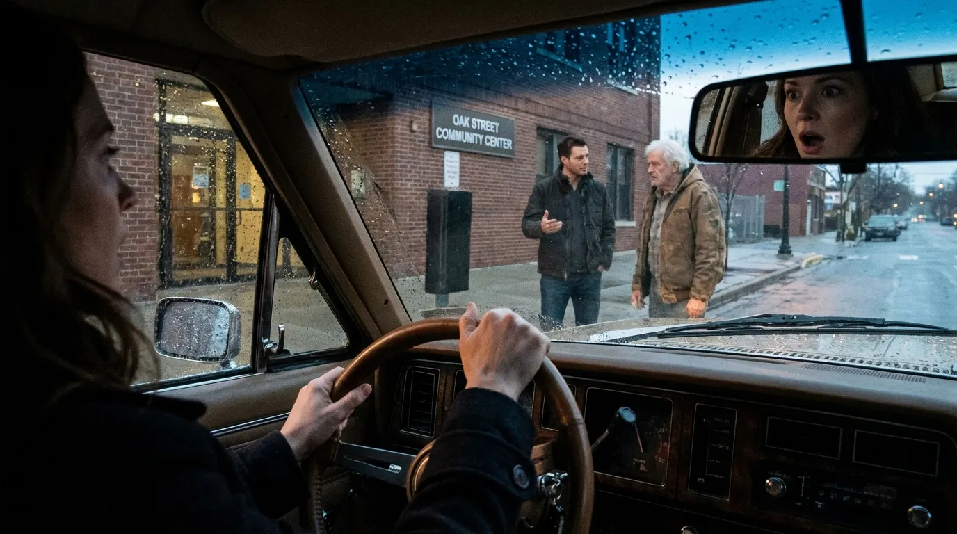 A woman gripping the steering wheel of her car, watching her husband outside a red-brick building.